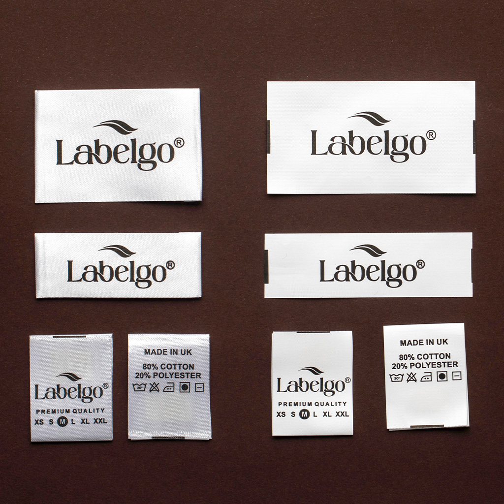 Plantilla con seis muestras de etiquetas de tela blancas impresas con el logotipo de LabelGo.